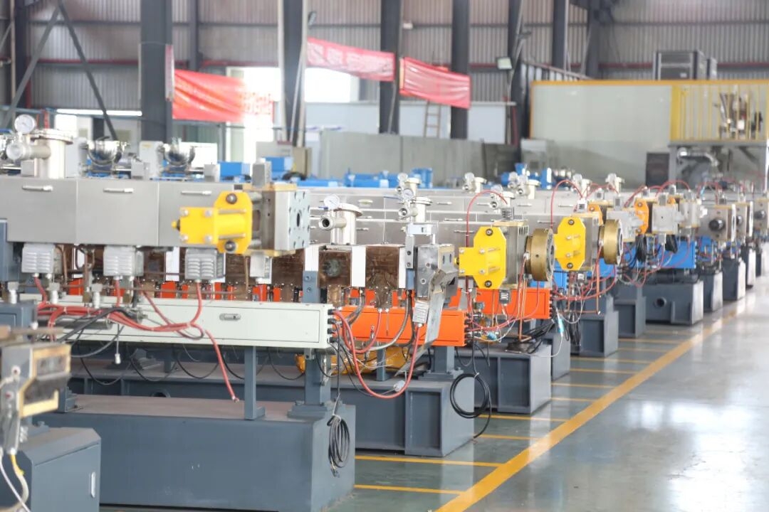 Engineers reviewing technical specifications and machinery blueprints in an industrial setting