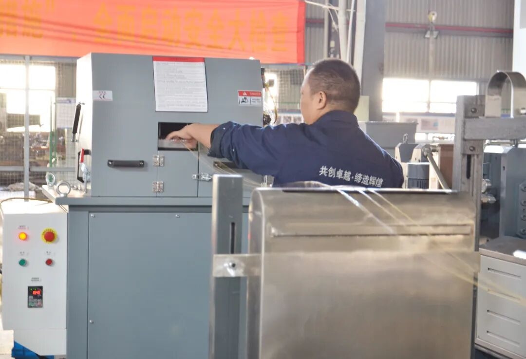 Engineer monitoring industrial machinery control panel in a modern manufacturing plant representing twin screw extruder opera