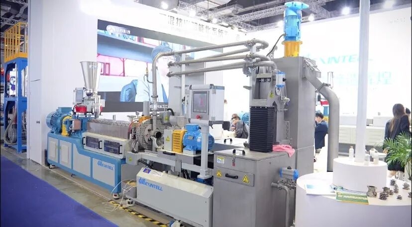 Industrial manufacturing facility interior with heavy machinery representing a twin screw pipe extruder factory production en