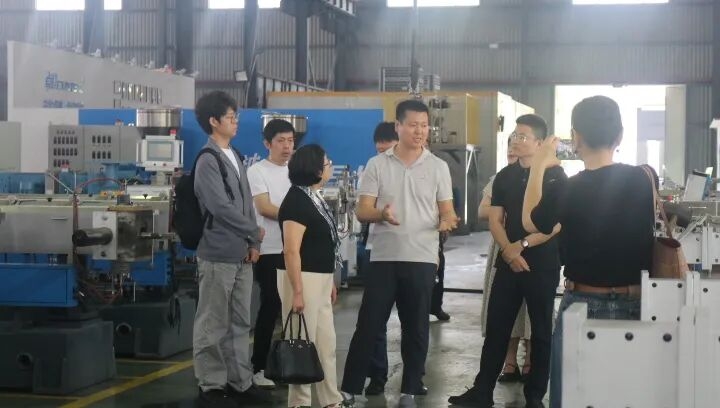 Engineer inspecting industrial manufacturing equipment in a modern factory setting for quality control