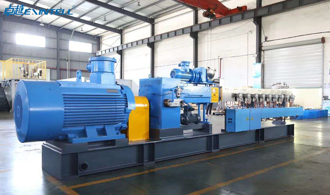 Close-up of extruder screw and barrel assembly with motor and gearbox drive